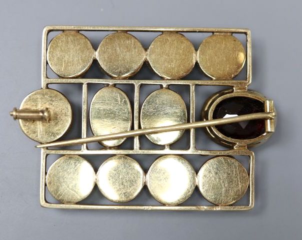 An early 20th century German jugendstil 585 yellow metal and facetted garnet set brooch,